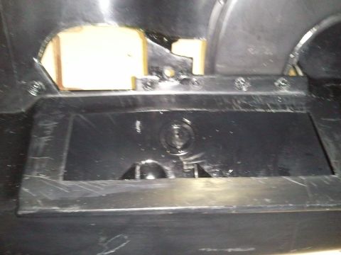 1994 Ford Bronco - Close-up of a car's interior dashboard compartment, showing internal components and construction.