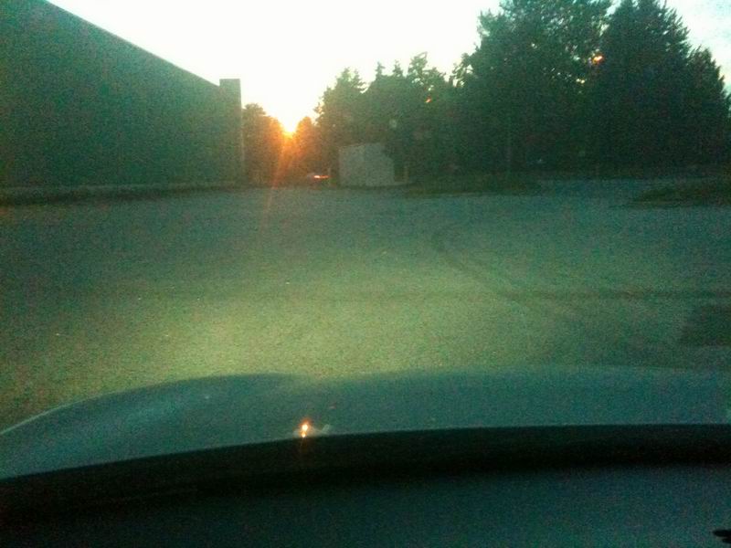 Dashboard view of road with sunset and Supermotors logo