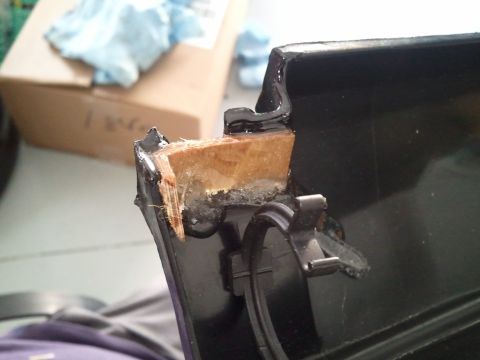 1994 Ford Bronco - Damaged dashboard trim reveals internal wood structure and adhesive.