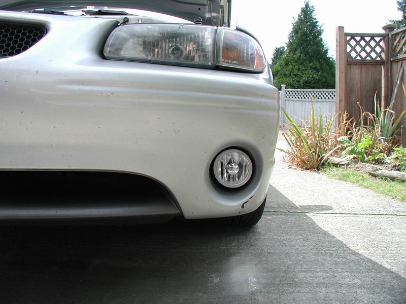 Silver 2002 Pontiac Grand Prix front bumper with a fog light and headlight visible
