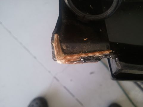 1994 Ford Bronco - Close-up view of damaged black dashboard trim, revealing layered material underneath.