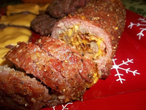 1989 Ford Bronco - Close-up of a sliced stuffed meatloaf served with cheeseburgers on a festive red plate.