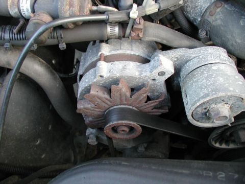 1990 Ford F-250 - This image shows a close-up view of a vehicle's alternator and drive belt system.