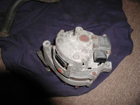 1990 Ford F-250 - Close-up of a vehicle alternator, a critical engine component.