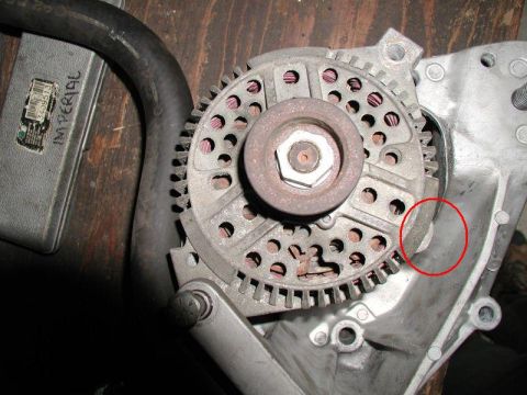 1990 Ford F-250 - Close-up view of an automotive alternator part, with visible text on an adjacent box.