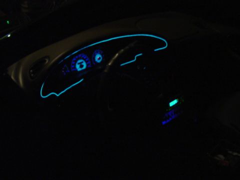 1999 Ford Taurus - The interior of a 1999 Ford Taurus features a dashboard with blue neon accent lighting and illuminated gauges.