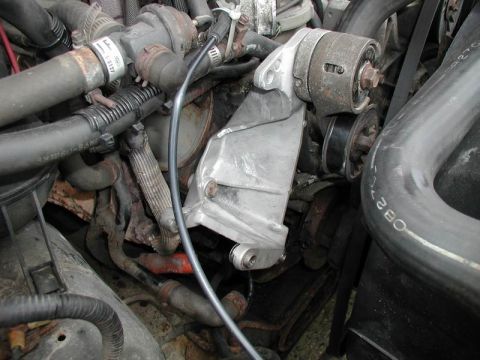 1990 Ford F-250 - This photo shows a close-up view of an engine's alternator bracket and associated pulleys and hoses.
