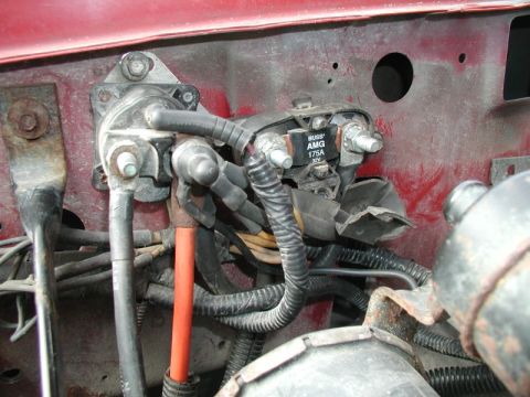 1990 Ford F-250 - Close-up view of the alternator wiring harness, a BUSS AMG 175A 32V fuse and various electrical connections.