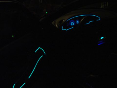 1999 Ford Taurus - Interior shot of a car with custom neon trim lighting visible on the dashboard and door.