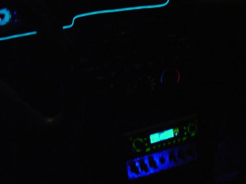 1999 Ford Taurus - The car's interior is illuminated by blue neon lights and a bright radio screen.