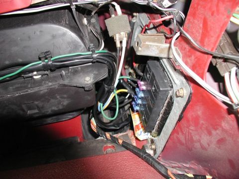 1990 Ford F-250 - Close-up view of a vehicle's CB radio wiring harness and fuse box, showing various wires and connections.