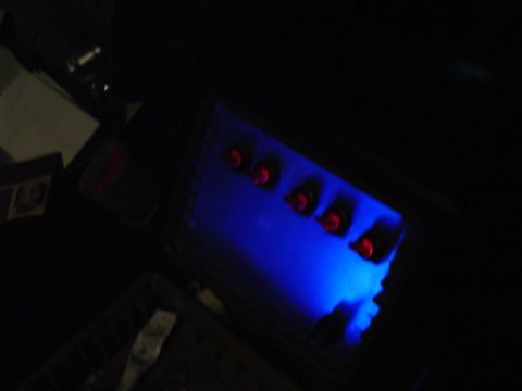 1999 Ford Taurus - Illuminated panel with red buttons, likely an aftermarket car accessory.