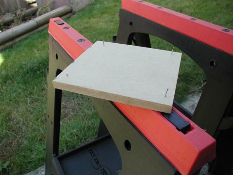 1990 Ford F-250 - A piece of material with nails is resting on a sawhorse.