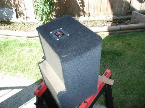 1990 Ford F-250 - A carpeted speaker enclosure sits on red sawhorses in a grassy yard.