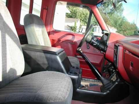 1990 Ford F-250 - Interior view of a 1990 Ford F-250, highlighting the center console and gear shifter.