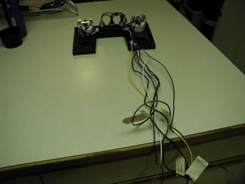 1990 Ford F-250 - Automotive wiring harness and gauges are shown on a table, with a watermark for Supermotors.net visible.