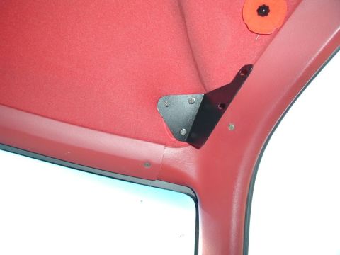 1990 Ford F-250 - Close-up of an aftermarket bracket mounted on the interior headliner of a vehicle.