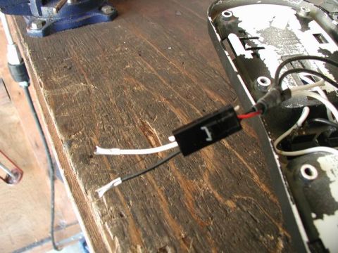 1990 Ford F-250 - Electrical components, including wires and a connector, are shown on a workbench, disconnected from their housing.