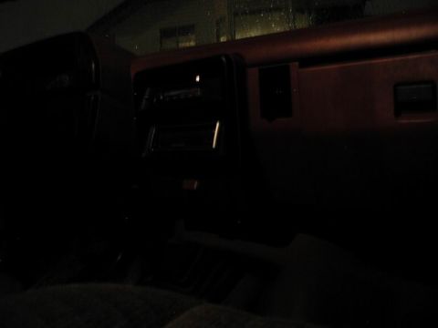 1990 Ford F-250 - Interior view of a vehicle at night, showing the dashboard and radio.