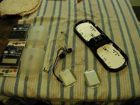 1990 Ford F-250 - Disassembled LED dome light components laid out on a striped cloth.