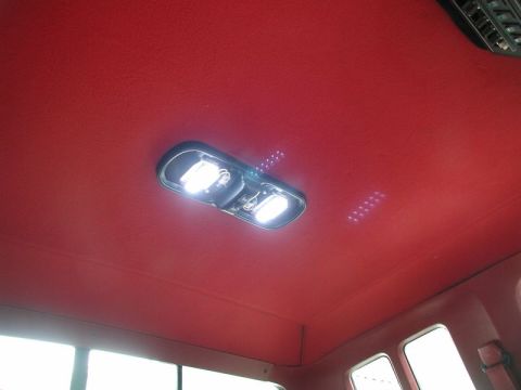 1990 Ford F-250 - Interior view of a vehicle's red headliner with a lit dome light assembly.