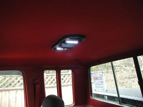 1990 Ford F-250 - The interior of a vehicle shows a red headliner and a newly installed LED dome light.