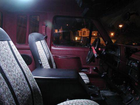 1990 Ford F-250 - The interior of a 1990 Ford F-250 pickup truck is visible, with a focus on the seats and dashboard area.