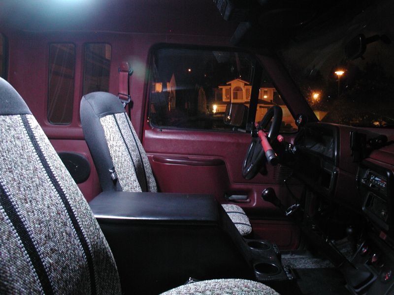Interior view of a 1990 Ford F-250 pickup truck, showing seats and dashboard