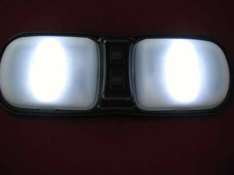 1990 Ford F-250 - This is a close-up of a vehicle's interior dome light assembly, showing its dual illumination and switch controls.