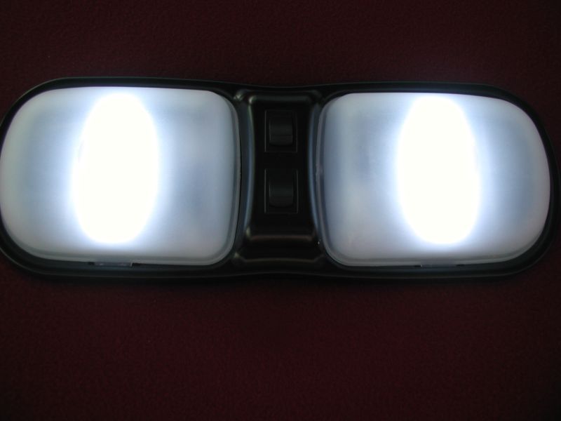 Interior dome light with two illuminated bulbs and two black switches