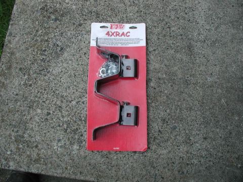 1990 Ford F-250 - A Hi-Lift 4xRAC jack mount kit is displayed on a concrete surface.