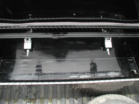 1990 Ford F-250 - Close-up of a hi-lift jack mount installed in a black truck bed.