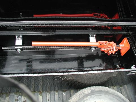 1990 Ford F-250 - Hi-Lift jack mounted in the bed of a truck, likely for off-road use.