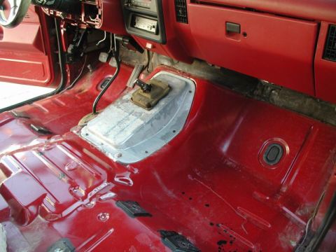 1990 Ford F-250 - The interior of a 1990 Ford F-250 shows a stripped-down floor, ready for a seat swap or restoration.