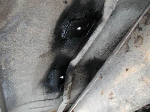 1990 Ford F-250 - A close-up view of the vehicle's frame shows a newly installed metal plate with bolt holes.