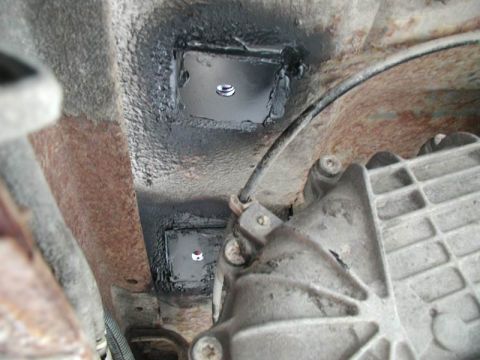 1990 Ford F-250 - Close-up view of the underbody, showing a transmission and newly installed mounting plates.