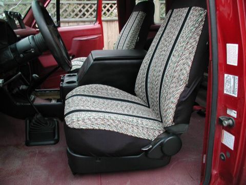 1990 Ford F-250 - The interior of a 1990 Ford F-250 shows off its patterned seat covers and a functional center console.