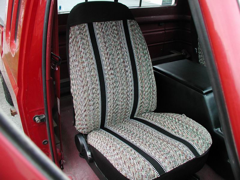 Red truck interior showing a patterned seat with black trim and a black console