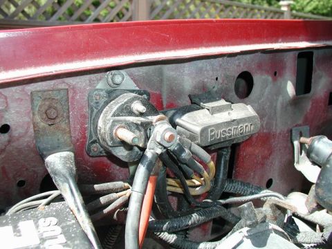 1990 Ford F-250 - Close-up of a vehicle's starter relay and associated wiring, with a visible fuse holder.