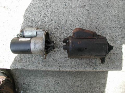 1990 Ford F-250 - Two starter motors are shown side-by-side on a concrete surface.