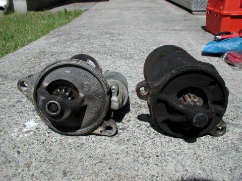 1990 Ford F-250 - A comparison of two vehicle starters, one appearing newer and the other heavily used and dirty.