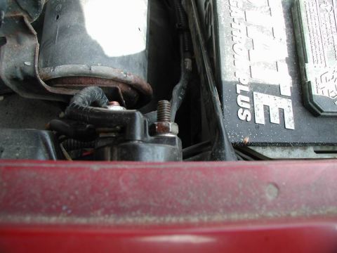1990 Ford F-250 - A close-up view of a vehicle's starter motor and battery terminals, showing electrical connections.