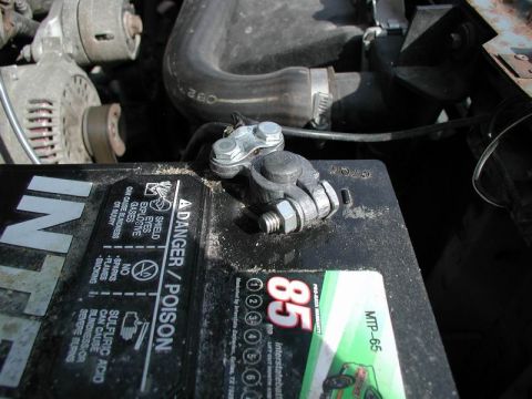1990 Ford F-250 - A car battery terminal and alternator are visible in the engine bay.