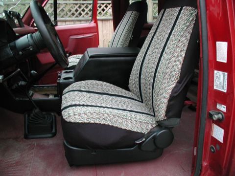 1990 Ford F-250 - The interior of a 1990 Ford F-250 shows its patterned seat covers and a black center console.