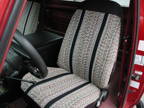1990 Ford F-250 - The patterned seat fabric and steering wheel are visible inside the cab of this 1990 Ford F-250 truck.