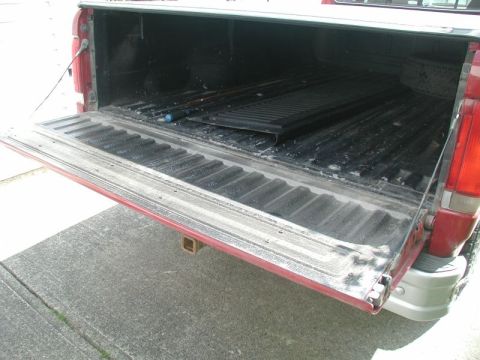 1990 Ford F-250 - Rear view of an open tailgate on a red 1990 Ford F-250 pickup truck.