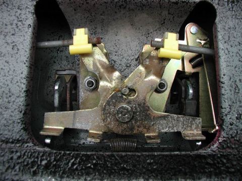 1990 Ford F-250 - Close-up view of a tailgate lock mechanism, showing its internal components and linkages.