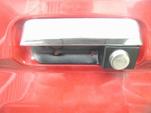 1990 Ford F-250 - The tailgate lock cylinder is visible on the right side of the handle assembly.
