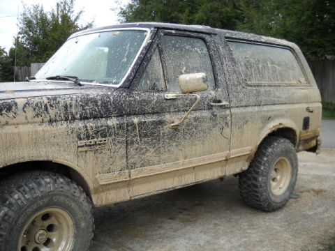 1990 Ford Bronco - This 1990 Ford Bronco is heavily covered in mud after off-roading.