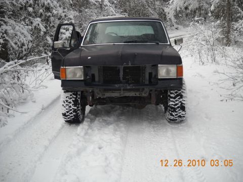 1990 Ford Bronco - This black SUV, possibly a Ford Bronco, is seen in a snowy environment with its driver's door ajar. A date stamp indicates it was photograp…